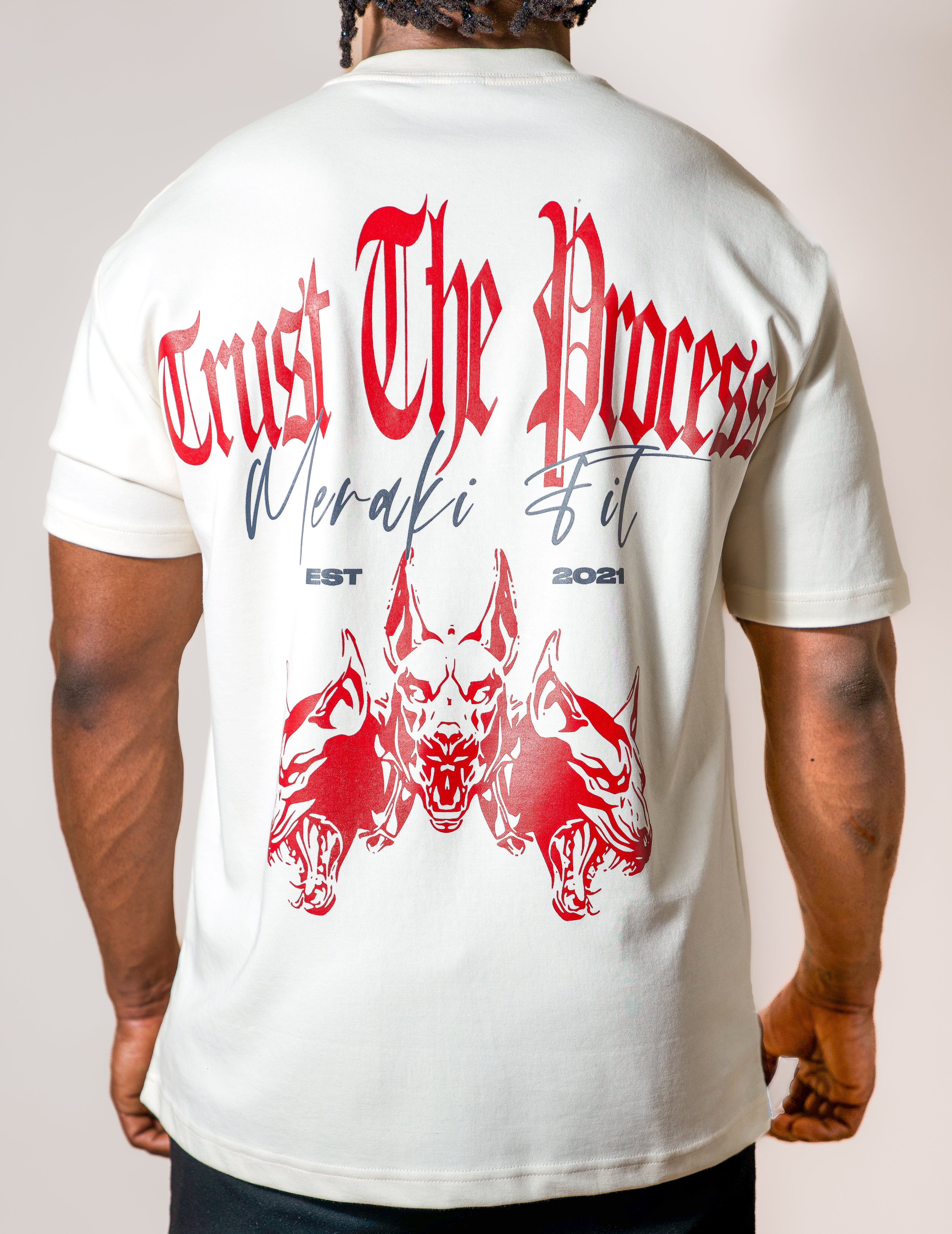 Person wearing a white t-shirt with red and black graphics and text on the back.